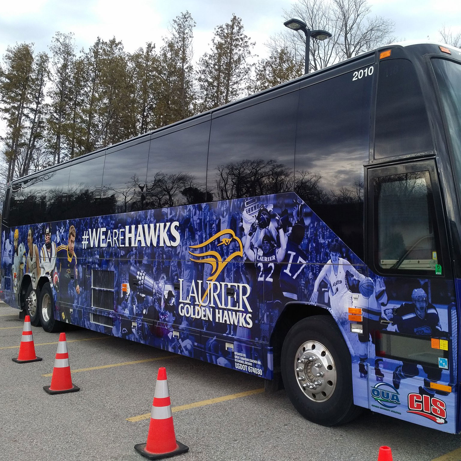 Full wrap design for the Laurier Golden Hawks' coach bus